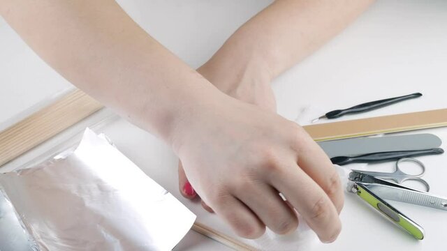 Removal of gel varnish using liquid with acetone and foil.
