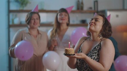 Oversize Woman holding Birthday Cake with candle and friends Congratulating on Background
