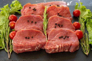 raw meat on a black background