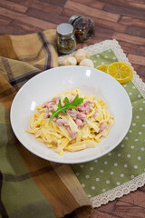 tasty pasta with roast ham on the table