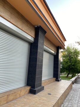 modern house with clothed rolets of the door