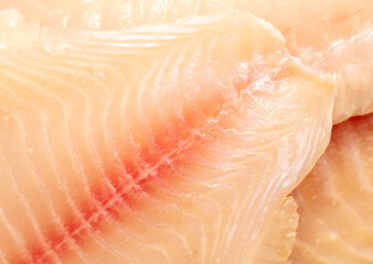 Tilapia fish fillet as background.