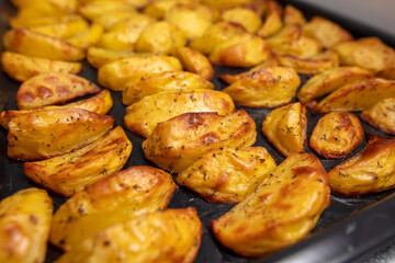 Baked potatoes in the oven as a background.