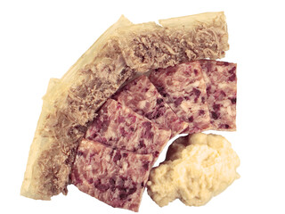 Homemade  Jellied veal, cold cut dish made from veal,  pork, stock, onion and spices, headcheese with slices of pork and beef and grated horseradish on a white background