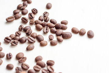 Roasted coffee beans on a wooden background. Coffee and light wood background. Seeds.