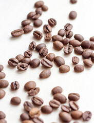 Roasted coffee beans on a wooden background. Coffee and light wood background. Seeds.
