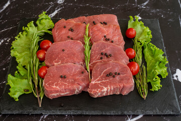 raw meat on a black background