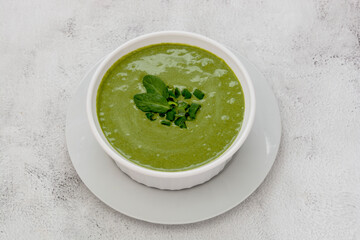 Healthy food. Spinach creamy soup with spinach on a light background. Spring food, dieting.