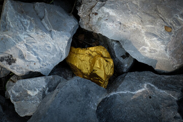 Gold nugget and grey granite stone background
