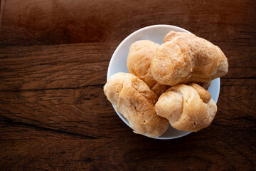 Small croissants on wooden background. Wallpaper, copy space, home-made.