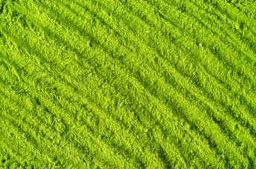 Matcha powder background. Green tea texture close up, selective focus