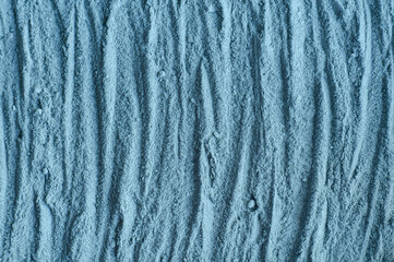Gray bentonite facial clay powder (kaolin clay, alginate mask, body wrap) texture close up, selective focus. Abstract background with brush strokes.