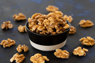 walnuts in bowl on black background