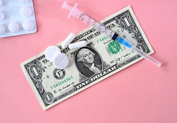Medicine and medical syringe. Dollar money.