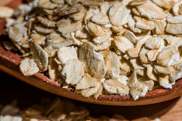 Dry rolled oat flakes oatmeal on old wooden table