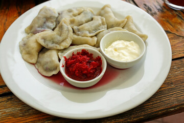 dumplings with blueberries with cream and strawberry mousse