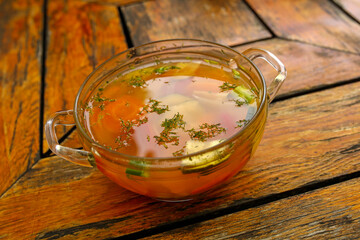 vegetable broth, minestrone soup on wooden table