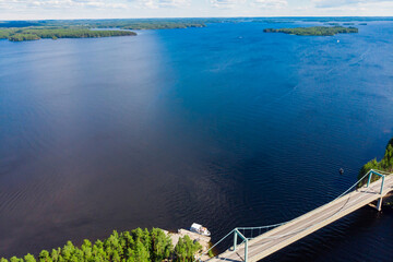Obraz premium Aerial view of Karisalmi bridge on Pulkkilanharju Ridge at lake Paijanne, Paijanne National Park, Finland.