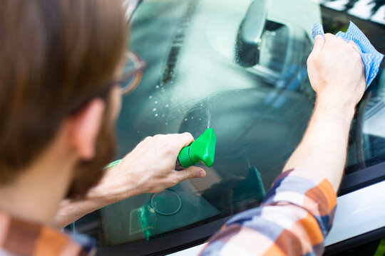 Auto detailing. Man cleaning a car with car cosmetics.