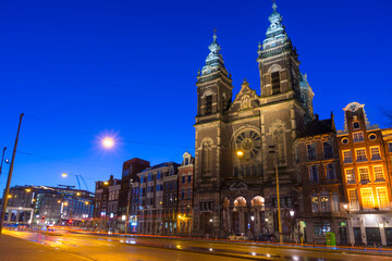 View of Basilica of Saint Nicholas at night time, near the Central railway Station,Amsterdam, Netherlands