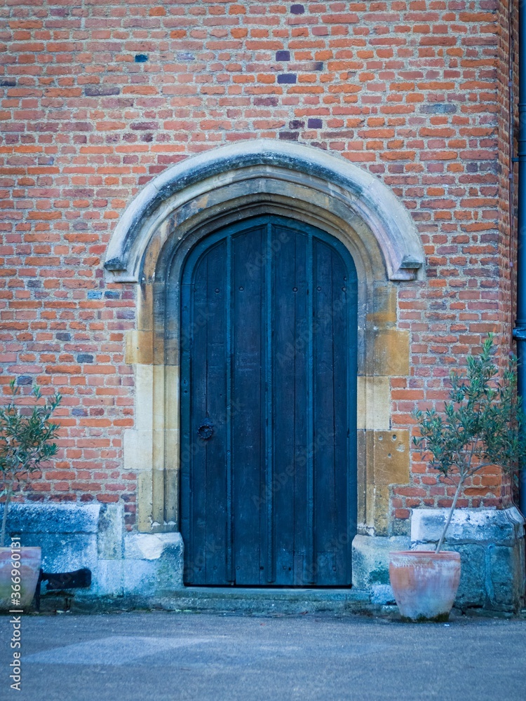 Wall mural wooden door of a building made of red bricks in oradea fortress oradea romania