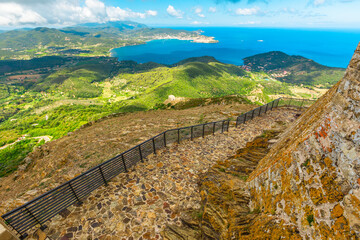 Naklejka premium Aerial view from top of the never conquered italian castle Volterraio. Oldest fortification on Elba Island, Tuscany, Italy, overlooking the gulf of Portoferraio. Panoramic views of Elba sea.