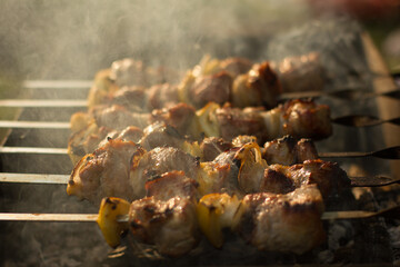 Cooking camping outdoor meal in an open fire in a travel pot with blaze. Dinner during travel.