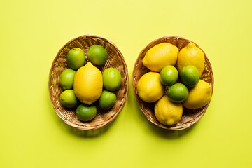 top view of ripe limes and lemons in wicker baskets on colorful background