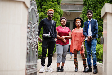 Fototapeta premium Four african friends having fun outdoors. Two black girls with guys.