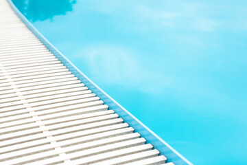 blue transparent pool water surface and white plastic side grating. For montage of your product
