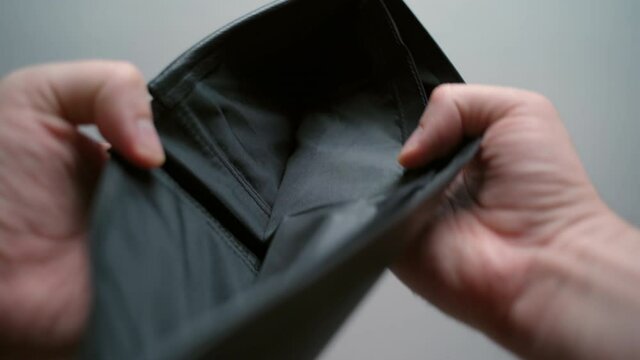 Global financial crisis and unemployment concept. Black empty wallet, no paper currency, change in the wallet. Financial saving and poverty