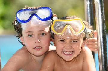 child playing in a swimming pool in summer