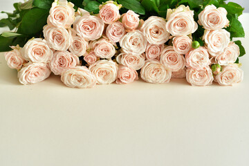 bouquet of delicate roses on a light background.Flowers composition. Flower card mockup. Mother's Day,Valentine's Day, February 14th, birthday.Congratulatory template. Wedding invitation.Copy space.