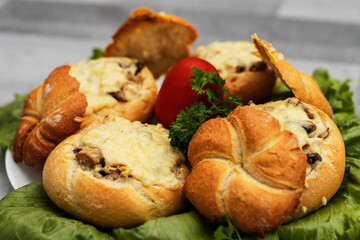 Buns and julienne baked buns with julienne in the middle, all on lettuce leaves