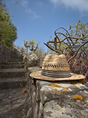 Men's beach hat placed at the beginning of a narrow stone staircase