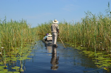 Local fishermen in a mokoro canoe on the Okavango Delta in Botswana