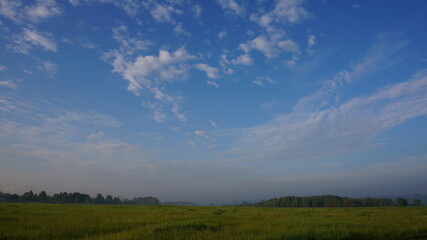 blue sky with clouds and a field