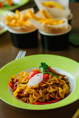 Farfalle pasta in a green plate.