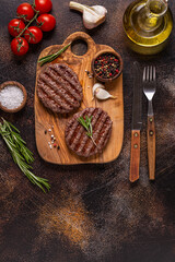 Fried cutlet for burger on a wooden board.