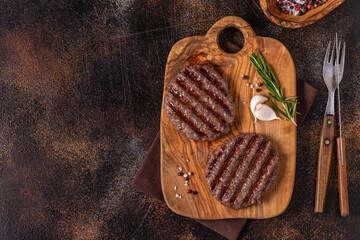 Fried cutlet for burger on a wooden board.