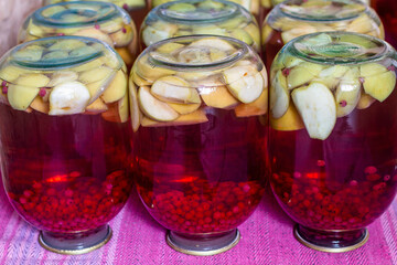 Homemade canned fruit compote for the winter. Compot from apples and red currant. Inverted jars