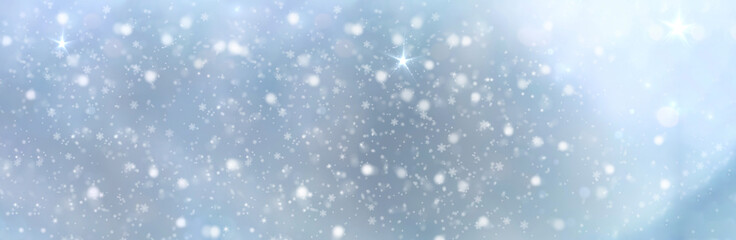 White snowflakes on a blue background fall from the sky - Christmas and winter background banner
