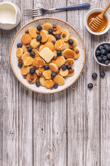 Trendy breakfast with mini pancakes, blueberries and chocolate chips.