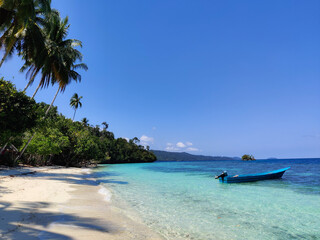 Boat on a paradise isolated beach in Raja Ampat, Papua, Indonesia