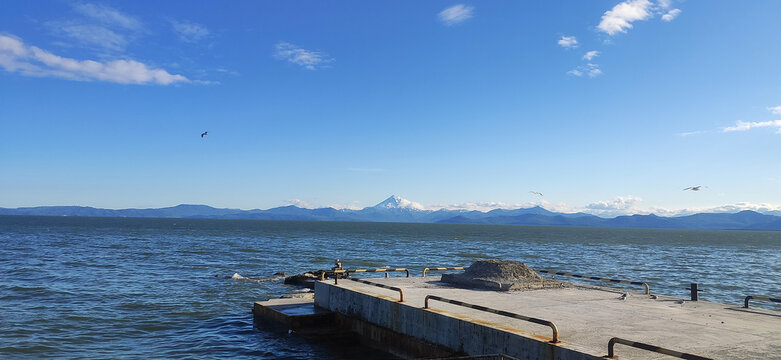 View of the Pacific Ocean Bay and the Vilyuchinsky Volcano hill in the background. Kamchatka Peninsula, Russia