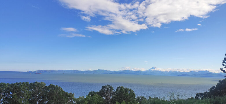 View of the Pacific Ocean Bay and the Vilyuchinsky Volcano hill in the background. Kamchatka Peninsula, Russia