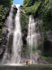 Couple under waterfall in Bali, Indonesia