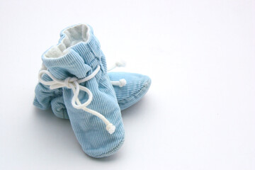 Fototapeta na wymiar Blue Baby Booties with White Background Copy Space. Can be used for Gender Reveal Party, Baby Shower, Baby Boy Birthday, etc.