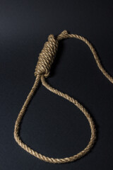 Loop from a rope on a black background. Social problem. The end of the path