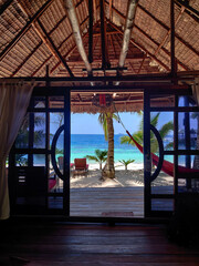 Turquoise beach view from inside cottage in a dreamy isolated paradise beach in Raja Ampat, Papua, Indonesia